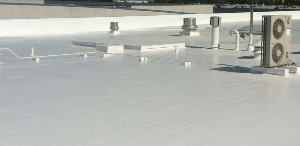 newly installed roof coating on a commercial roofing system