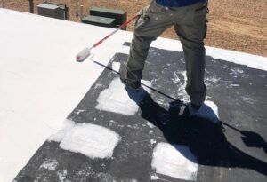 man performing a roof coating